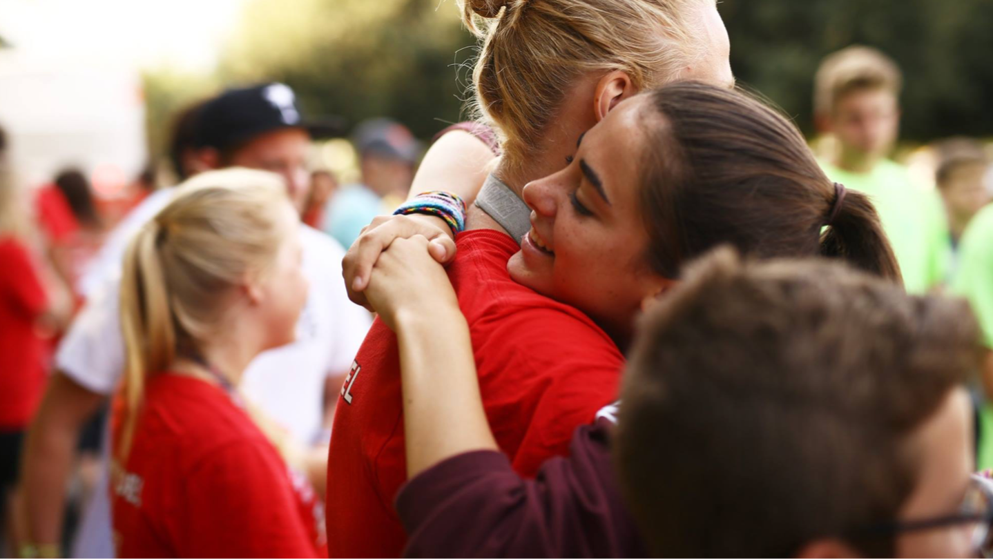 Campers hugging.