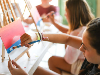 A camper painting a sunset scene.