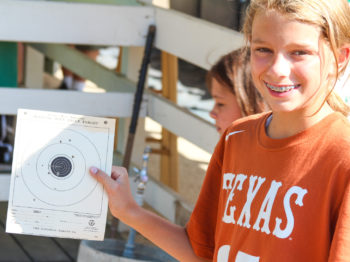 A camper showing their bb gun target sheet.