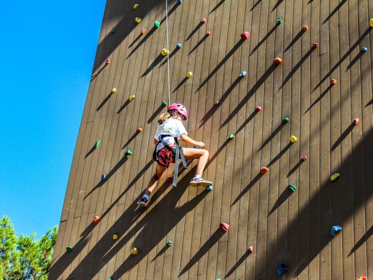 A view of a camper climbing the rock wall.