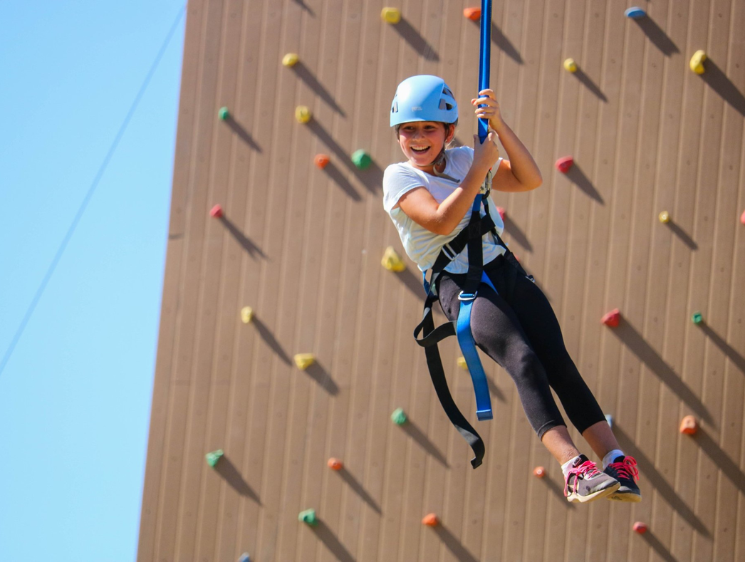 A camper on a climbing wall.