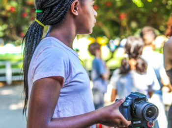 A camper setting up her camera for a photo.