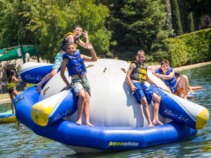 Campers standing on a Rock-it and smiling.