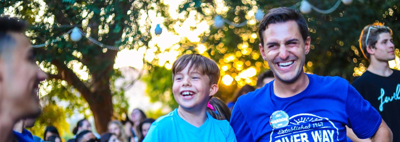 A camper and a counselor laughing